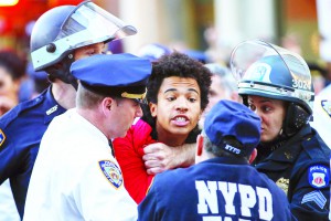 New York Police Department officers detain a protester during a march through the Manhattan borough of New York City calling for social, economic, and racial justice April 29, 2015. Billed as "NYC Rise Up & Shut it Down With Baltimore", the demonstration was being held to support Baltimore's protests against police brutality following the April 19 death of Freddie Gray in police custody. REUTERS/Mike Segar